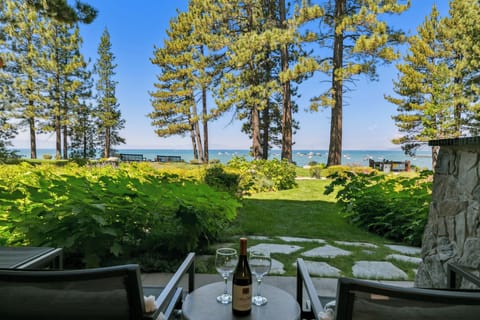 Relax on your private patio while gazing at the sparkling lake through towering pines—pure serenity awaits.