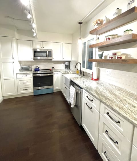 Kitchen amenities include coffee maker, toaster, microwave and tea kettle