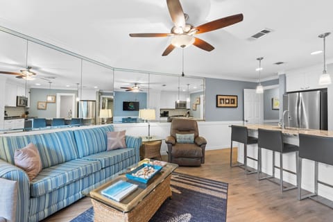 Living room featuring fresh decor done in coastal colors and art. Flat screen TV w/cable.