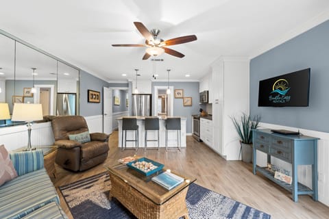 Living room featuring fresh decor done in coastal colors and art. Flat screen TV w/cable.