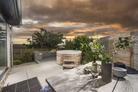 Dusk shot of the patio and hot tub - 6 The Dunes, Upton Towans