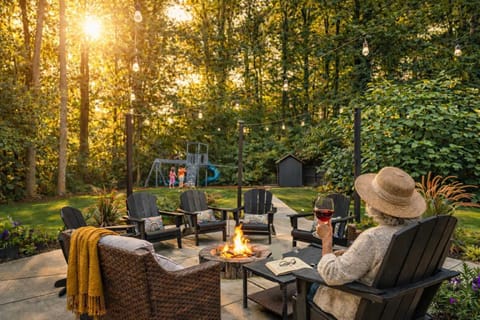 Step outside where the fire pit glows and string lights trace the treeline — pour something cold, pull up a chair, and stay until the stars come out.
