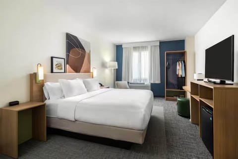 Premium bedding, desk, laptop workspace, blackout drapes