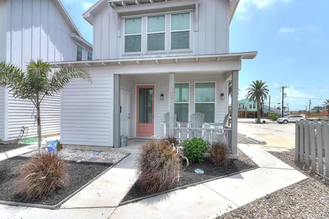 Charming coastal cottage with covered porch and modern beachside styling in a quiet neighborhood setting.