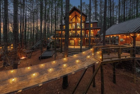 Bordering the Natl Forest with endless obstacle course setup: 75+ ft of slides (5 total slides), 78ft of rope brides, multiple platforms (rock walls, fire pole, rope climbs and more), and endless acres of forest right behind the cabin.