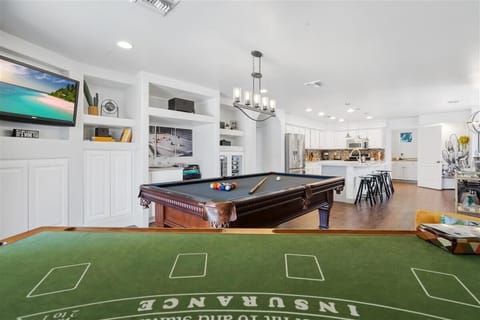 Black jack and game room, pool table, martini bar area with TV