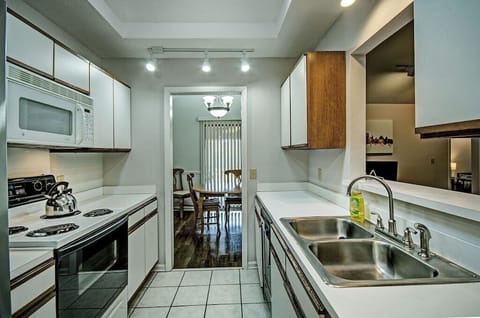 In the kitchen, there is plenty of dishware, glassware, silverware, and utensils