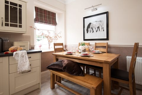 School View - dining space with bench seating and chairs for four