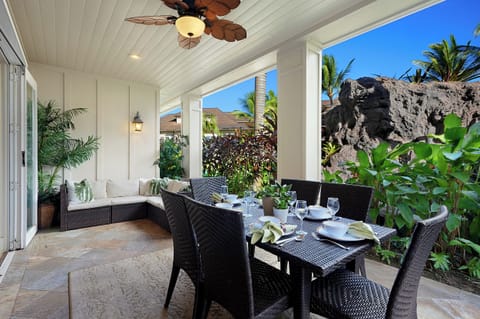 Private lanai offering a peaceful outdoor dining experience at Villas at Poipu Kai B111 surrounded by lush greenery.