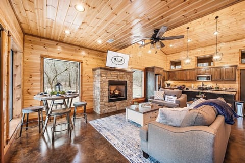 Love the open concept of the den, dining room pub table, and kitchen!