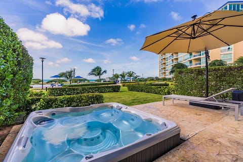 Patio w/ lounge chair, umbrella, and a private hot tub