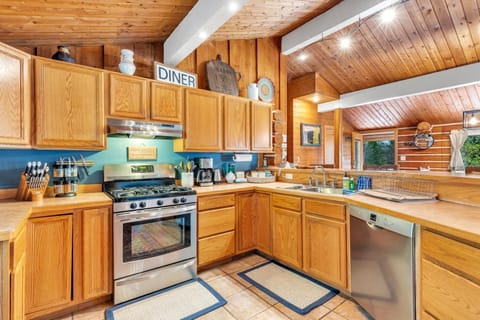 The fully stocked kitchen with all updated appliances and vaulted ceilings.