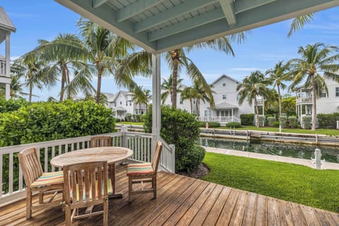 Lower level canal side porch with seating: perfect for your morning coffee