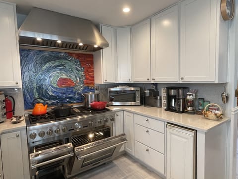 The Thermador range with oven, convection, steam oven, double griddle, 6 burner stove top and pot filler will make any large meal prep easier.