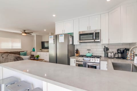 Newly remodeled kitchen with quartz counters and stainless steel appliances