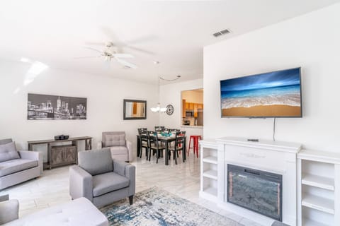 Open Living/Dining with Flatscreen TV with Cozy Fire Place