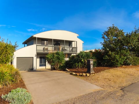Front view of house, parking in the driveway, plus three parks out the front