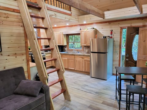 view from living room showing ship ladder to access loft