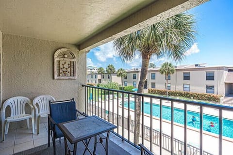 Balcony: table, chairs, pool view; perfect for relaxation and gatherings.
