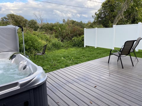 Back deck &  (extra fee) hot tub.  Propane grill, cafe table/chairs, fire pit