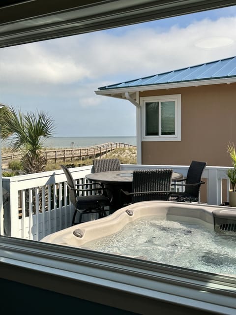 Enjoy a soak in the hot tub as you watch ships pass by, and dolphins swim past.