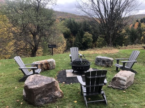 outdoor fire pit area with gazebo and gas grill 