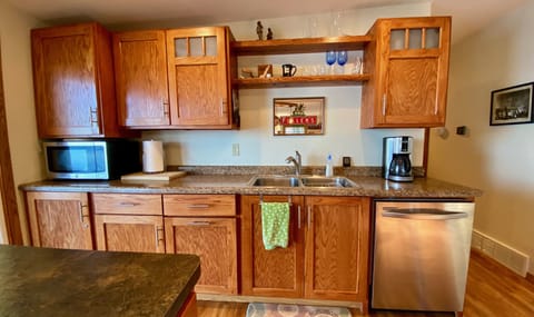 Well equipped kitchen w/stainless dishwasher, microwave, range, and refrigerator