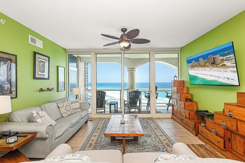 Relax in your bright living room with stunning ocean views through floor-to-ceiling windows and enjoy modern comfort.