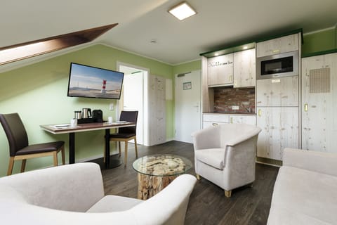 Apartment, 1 Bedroom | Living area | 32-inch flat-screen TV with satellite channels, TV