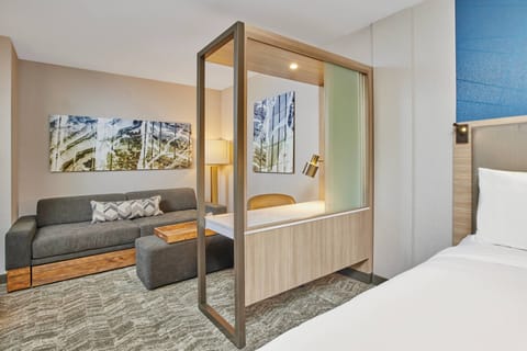 Desk, laptop workspace, iron/ironing board, bed sheets