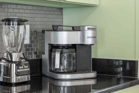 tart your day with a fresh brew from this sleek Keurig machine, a convenient touch in the well-appointed kitchen, ensuring a warm cup of comfort is never more than a moment away.