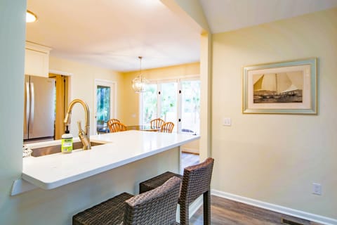 There are two high top stools near the kitchen counter.