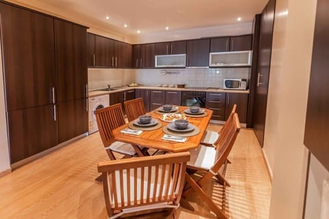 Fully Equipped Kitchen with Dining Area
Includes modern appliances, ample countertop space, and a spacious dining table for shared meals.