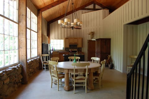 Dining area and kitchen, with floor to ceiling windows looking over the canyon