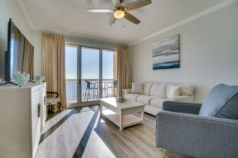 Sink into plush sofas in your bright living room, where ocean views through sliding doors create a serene backdrop for relaxation.
