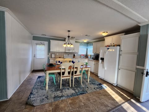 Full kitchen with glass top stove and oven, dishwasher and more.
