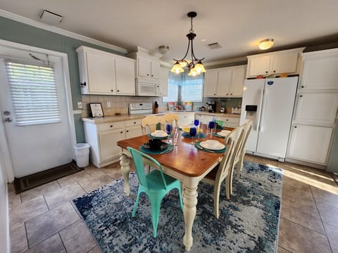 Full kitchen with glass top stove and oven, dishwasher and more.