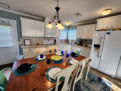 Full kitchen with glass top stove and oven, dishwasher and more.