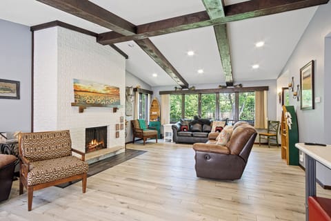 Beautiful living room with wood burning fire place and views of the water.