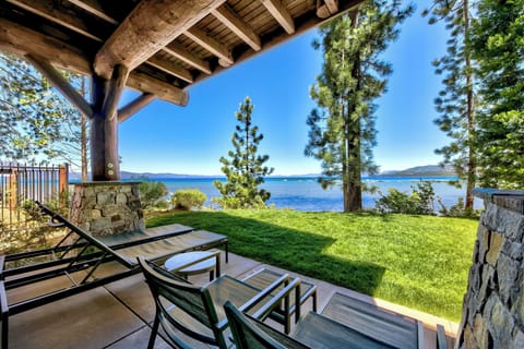 Unwind on your private lakefront patio with stunning water views, comfortable seating, and direct access to pristine lawn and shoreline.