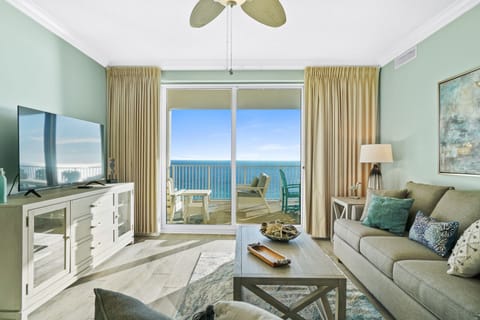 Relax in your coastal living room where ocean breezes flow through sliding doors and endless sea views create the perfect backdrop for unwinding.