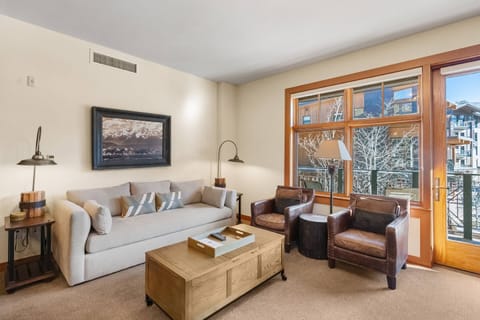 Enjoy this cozy living room with fireplace and tv after skiing or hiking