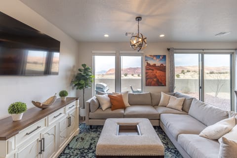 Living Room Side View - The living room is conveniently adjacent to the kitchen. There is also access to the back patio which has a BBQ grille suitable for all your favorite BBQ dishes.