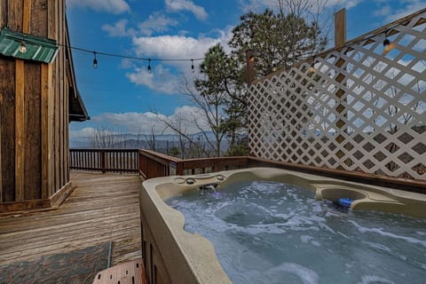 Soak in the private hot tub while taking in peaceful views.
