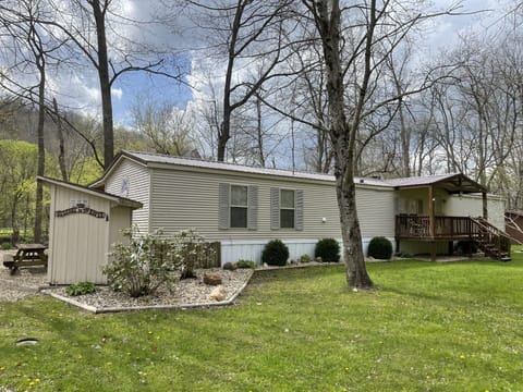 A view of the house/outdoor bathroom from the front upon access to the property.