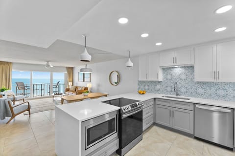 Start your morning by brewing a fresh cup of coffee in this bright, modern kitchen.