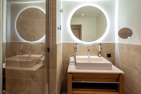 Designer toiletries, hair dryer, slippers, towels