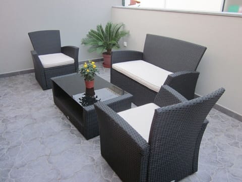 Balcony with rattan table and chairs