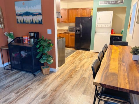 Dining area connecting kitchen with living room, coffee bar with tea, coffee, sweeteners, and creamers provided. Laundry also in unit.