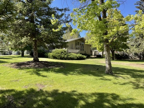 The home has a large grass yard on 3 sides.